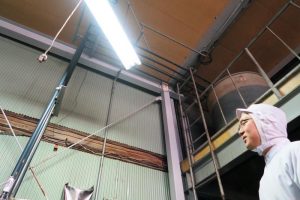 小森さんの頭上にあるタンクには、お店こだわりの醤油が入っている。仕入れた醤油は写真左の管からタンクへと運ばれる。機能的な配管に目をうばわれる